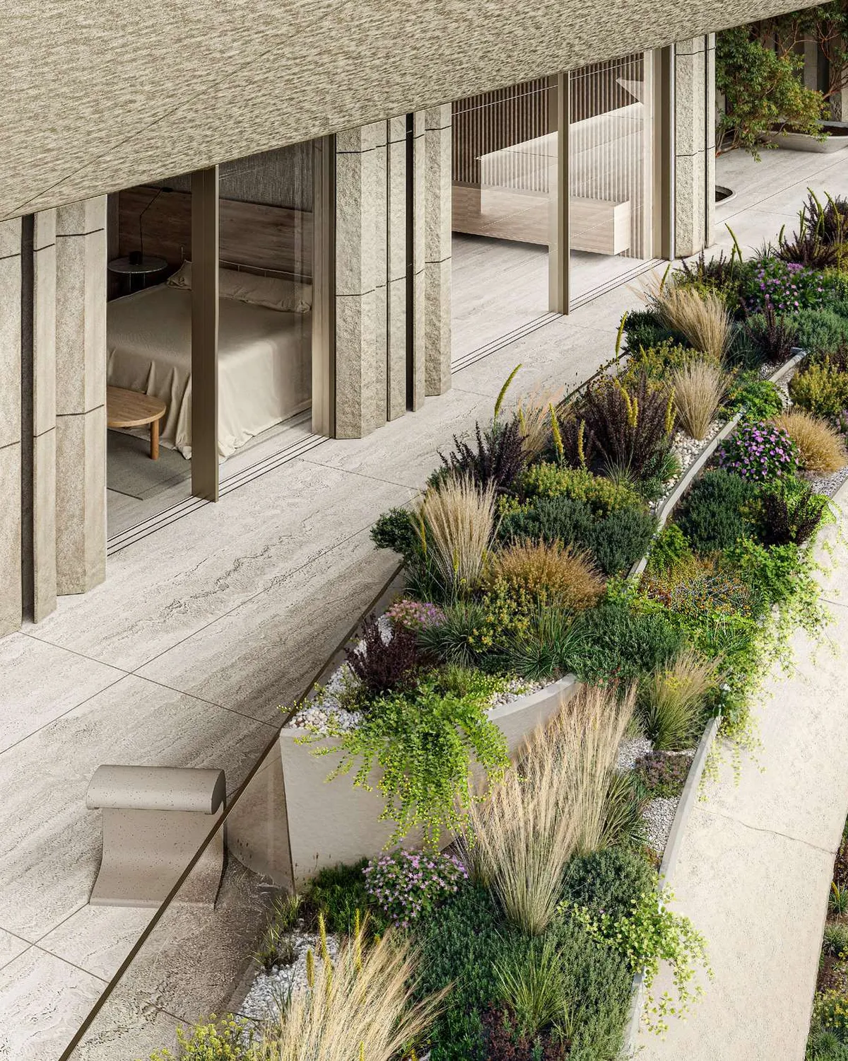 Stone terrace lined with lush planting outside a bedroom