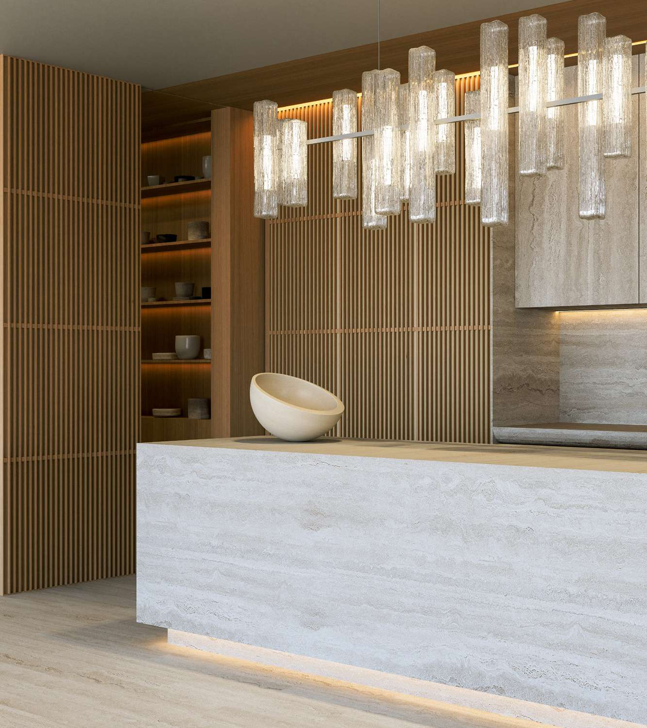 Travertine kitchen island beneath glass pendant lights and slatted timber walls