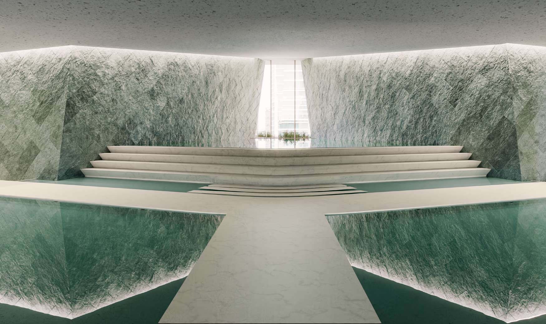 Indoor lagoon framed by green stone walls and stepped marble
