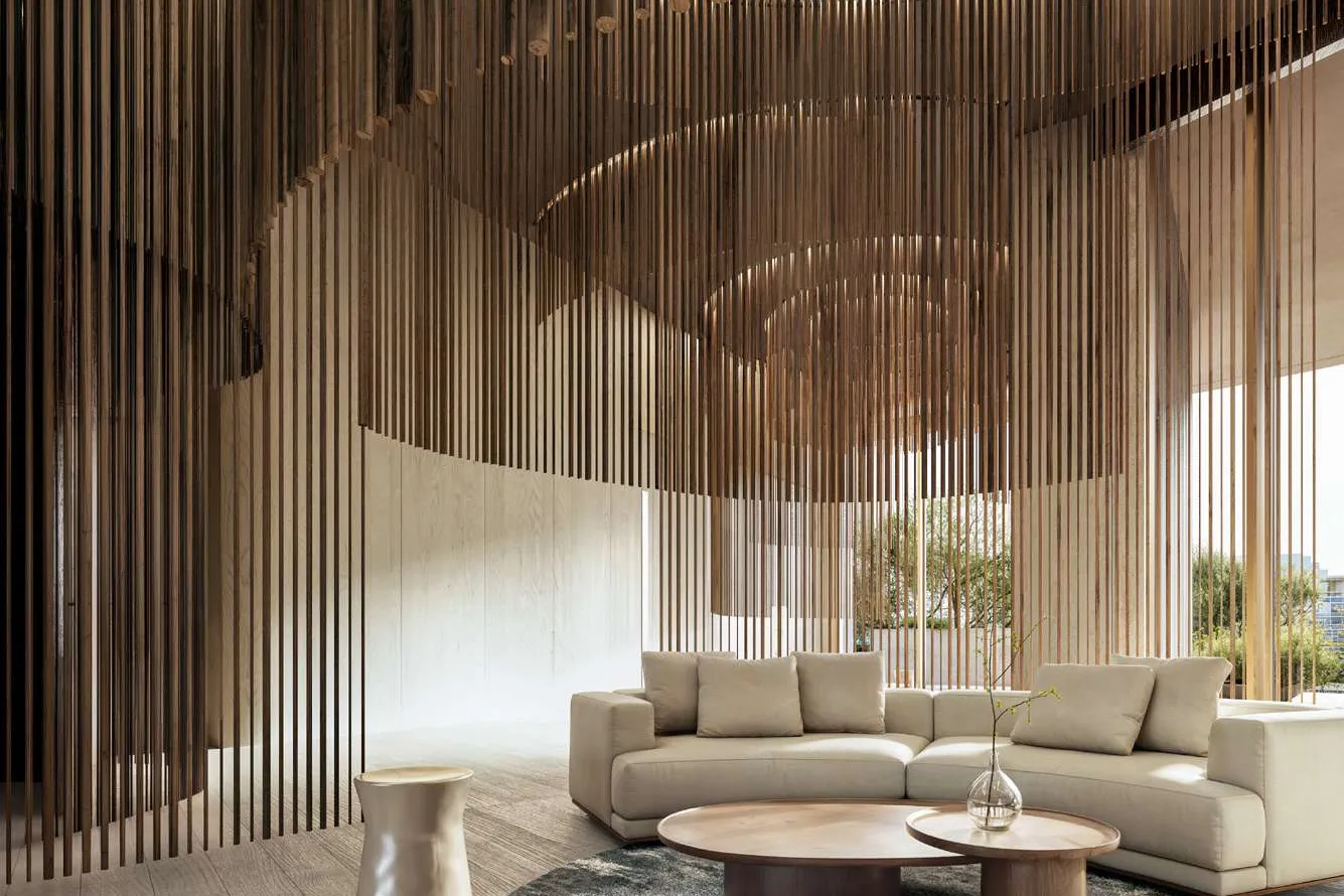 Lounge with cream sofa under a canopy of hanging timber rods