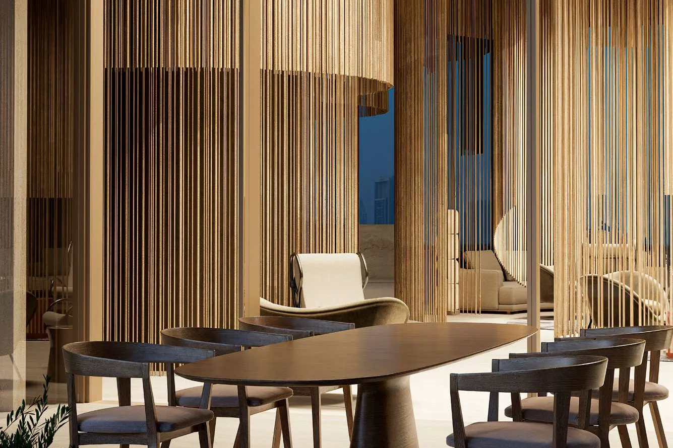 Oval dining table with timber chairs among golden hanging screens